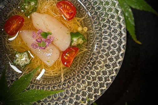 凹凸のある涼しげなガラスの器に盛り付けられた、魚介料理。